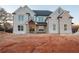 Stunning new construction home featuring a light brick facade, a covered porch, and complementary stone accents at 3255 Hall Rd, Dacula, GA 30019