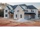 Beautifully crafted new home showcasing a painted brick facade, black roof and trim, plus an attached two-car garage at 3255 Hall Rd, Dacula, GA 30019