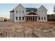 New construction home with brick exterior, ample windows, and a covered back porch ready for outdoor living at 3255 Hall Rd, Dacula, GA 30019