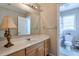 Bathroom with a decorative lamp, framed mirror, under sink storage and toilet with window at 3466 Northfield Nw Way, Kennesaw, GA 30144