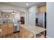 Kitchen featuring stainless steel appliances, an island, granite countertops, an archway to the living room, and wood floors at 3466 Northfield Nw Way, Kennesaw, GA 30144