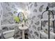 Powder room features decorative wallpaper, a pedestal sink, an oval mirror, and decorative accents at 3466 Northfield Nw Way, Kennesaw, GA 30144