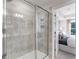 Modern bathroom with a tiled shower, glass door, and easy access to the bedroom offering comfort and convenience at 5841 Schelton Se Pl, Mableton, GA 30126