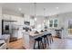 Bright kitchen with island, modern appliances, white cabinetry and pendant lighting at 5841 Schelton Se Pl, Mableton, GA 30126