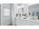 Bathroom with double vanity, white cabinets, and a large window for natural light at 1048 Standard Ne Dr, Atlanta, GA 30319