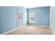 A simple, yet cozy carpeted bedroom featuring two windows and light blue walls at 1048 Standard Ne Dr, Atlanta, GA 30319