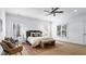 Bright main bedroom with a ceiling fan, two windows, and a stylish decorative rug at 1048 Standard Ne Dr, Atlanta, GA 30319