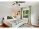 Cozy bedroom with neutral decor, ceiling fan, and a view of the landscaped yard at 4027 Finch Sw Rd, Powder Springs, GA 30127