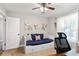 Bedroom featuring a trundle bed, desk, and window with curtains for privacy at 4027 Finch Sw Rd, Powder Springs, GA 30127