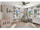 Well lit Bedroom with neutral walls, a crib, a gray chair, and a white dresser at 4027 Finch Sw Rd, Powder Springs, GA 30127