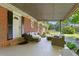 Spacious covered patio with outdoor seating and views of the lush backyard at 4027 Finch Sw Rd, Powder Springs, GA 30127