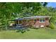Cozy brick home featuring an inviting covered patio and a beautifully maintained lawn at 4027 Finch Sw Rd, Powder Springs, GA 30127
