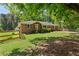 Charming single-story brick home with a well-maintained lawn and fenced front yard at 4027 Finch Sw Rd, Powder Springs, GA 30127
