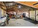 Spacious garage with ample storage, workbench, and exercise equipment at 4027 Finch Sw Rd, Powder Springs, GA 30127