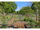 Lush garden featuring raised beds and a variety of plants, surrounded by greenery at 4027 Finch Sw Rd, Powder Springs, GA 30127