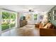 Inviting living room boasts wood floors, a ceiling fan, and sliding glass doors with backyard views at 4027 Finch Sw Rd, Powder Springs, GA 30127