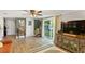 Comfortable living room with wood floors, a ceiling fan, sliding glass doors, and stylish decor at 4027 Finch Sw Rd, Powder Springs, GA 30127