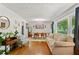 Open-concept living room and dining area with hardwood floors and lots of natural light at 4027 Finch Sw Rd, Powder Springs, GA 30127