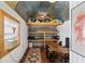 Functional office space in outbuilding with desk, shelves, and comfortable workspace at 4027 Finch Sw Rd, Powder Springs, GA 30127