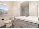 Bathroom featuring updated vanity and countertop, toilet, mirror, and window at 5419 Golfcrest Cir, Stone Mountain, GA 30088