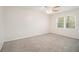 Bright bedroom with neutral carpet, white walls, and ceiling fan at 5419 Golfcrest Cir, Stone Mountain, GA 30088