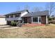 Inviting two-story house featuring a brick facade, bay window, and landscaped front yard with mature trees at 5419 Golfcrest Cir, Stone Mountain, GA 30088