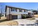 Classic two-story home with a brick and siding exterior, attached garage, and manicured landscaping at 5419 Golfcrest Cir, Stone Mountain, GA 30088