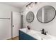 This bathroom features a dual vanity, matte black hardware, and modern lighting at 1003 Cumberland Se Ct # 1003, Smyrna, GA 30080