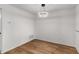 Dining room with modern light fixture, white walls, and wood floors at 1003 Cumberland Se Ct # 1003, Smyrna, GA 30080