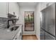 Kitchen with a stainless steel refrigerator, sink, and white cabinets by the window at 1003 Cumberland Se Ct # 1003, Smyrna, GA 30080