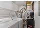 This laundry room features white machines, wire rack shelving, and a water heater at 1003 Cumberland Se Ct # 1003, Smyrna, GA 30080