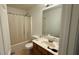 Bathroom featuring a vanity with a sink, toilet, shower with curtain, and a large mirror at 1530 Viero Dr, Lawrenceville, GA 30044