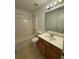 Bright bathroom features a tub and shower, a toilet, and a vanity with cabinet storage at 1530 Viero Dr, Lawrenceville, GA 30044