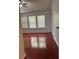 Bedroom featuring wood-look floors, bright windows, and a ceiling fan at 1530 Viero Dr, Lawrenceville, GA 30044