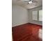 Bedroom featuring wood-look floors, bright windows, and a ceiling fan at 1530 Viero Dr, Lawrenceville, GA 30044