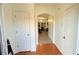 Inviting hallway with decorative archway and a mix of wood and wood-look floors at 1530 Viero Dr, Lawrenceville, GA 30044