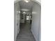 Inviting hallway with modern gray flooring and chandelier view at 1530 Viero Dr, Lawrenceville, GA 30044
