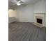 Bright living room with modern flooring, fireplace, and a ceiling fan at 1530 Viero Dr, Lawrenceville, GA 30044