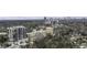 Aerial view of a high-rise apartment near wooded area and skyline in the distance at 2233 Peachtree Ne Rd # 902, Atlanta, GA 30309