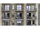 Multiple balconies of a high-rise apartment building featuring wrought iron railings and exterior brick facade at 2233 Peachtree Ne Rd # 902, Atlanta, GA 30309