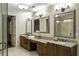 Bright bathroom with dual sinks, granite countertops, and framed mirrors at 2233 Peachtree Ne Rd # 902, Atlanta, GA 30309