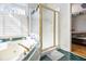 A bathroom featuring a tiled jacuzzi tub beside a glass shower at 4559 Cabinwood Turn, Douglasville, GA 30135