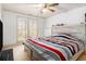 Bedroom with a window, wood-look headboard, a ceiling fan, and neutral carpet at 4559 Cabinwood Turn, Douglasville, GA 30135