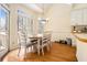 Cozy dining area with a modern chandelier, hardwood floors, and lots of natural light at 4559 Cabinwood Turn, Douglasville, GA 30135