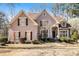 Charming two-story home with a manicured lawn and traditional architectural details at 4559 Cabinwood Turn, Douglasville, GA 30135