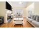 Bright living room featuring a stone fireplace, hardwood floors, and lots of natural light at 4559 Cabinwood Turn, Douglasville, GA 30135