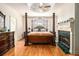 Elegant main bedroom featuring a fireplace, hardwood floors, and a four poster bed at 4559 Cabinwood Turn, Douglasville, GA 30135