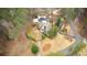 Aerial view of home nestled in a wooded lot with a circular driveway at 4770 Hilltop Nw Dr, Acworth, GA 30101