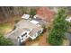 Aerial view of a home surrounded by lush landscaping, multiple outbuildings and a long driveway at 4770 Hilltop Nw Dr, Acworth, GA 30101