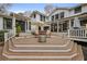 Multi-tiered back deck with furniture, umbrella, and an outdoor fireplace feature at 4770 Hilltop Nw Dr, Acworth, GA 30101